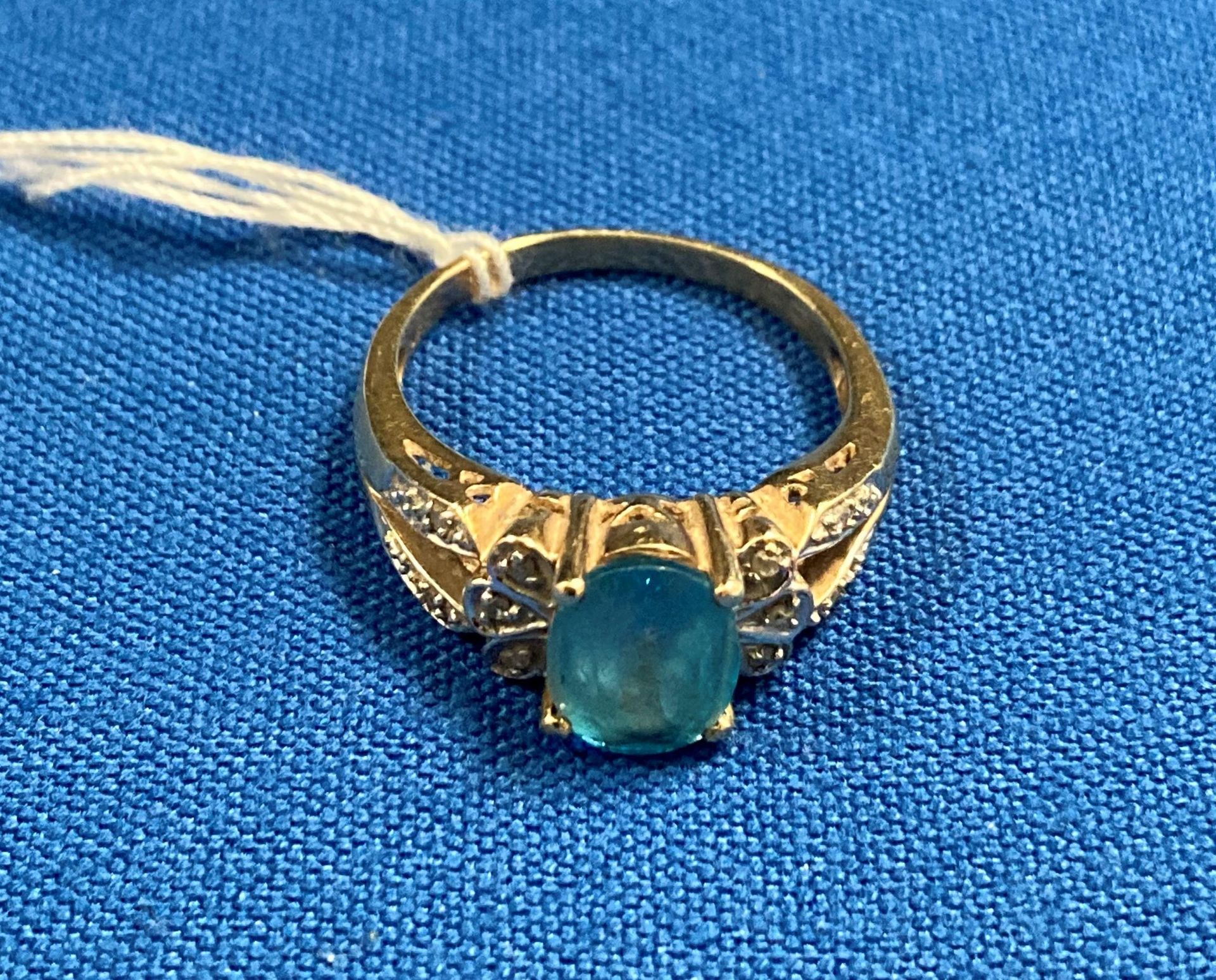 9ct gold (375) with small diamonds and central oval light-blue stone (possibly aquamarine) size Q.