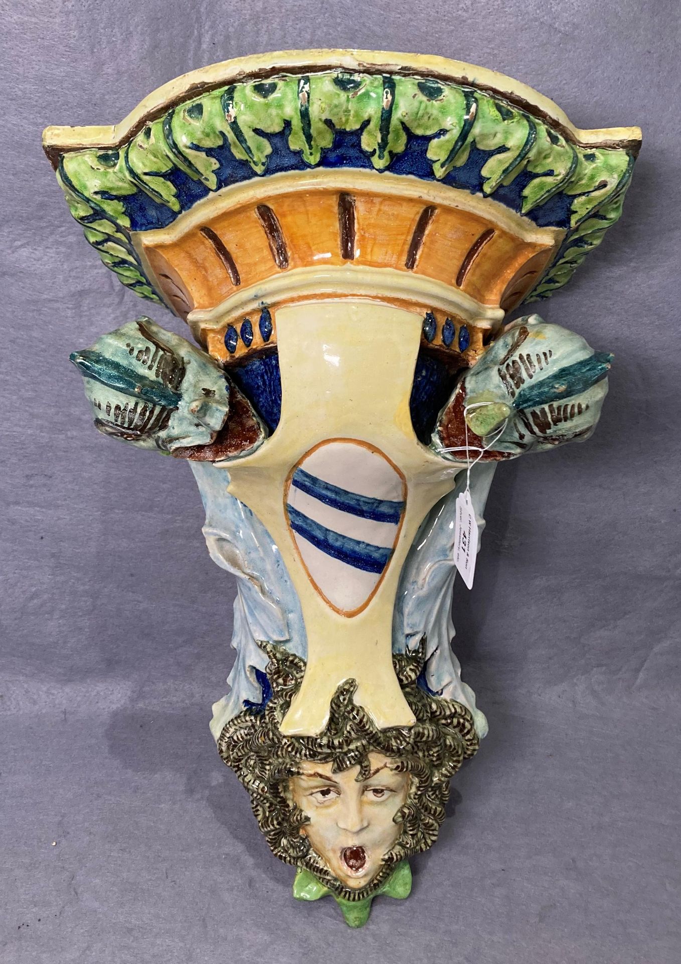 A vintage Majolica ceramic wall shelf/bracket with Medusa's head to bottom with sea serpents either