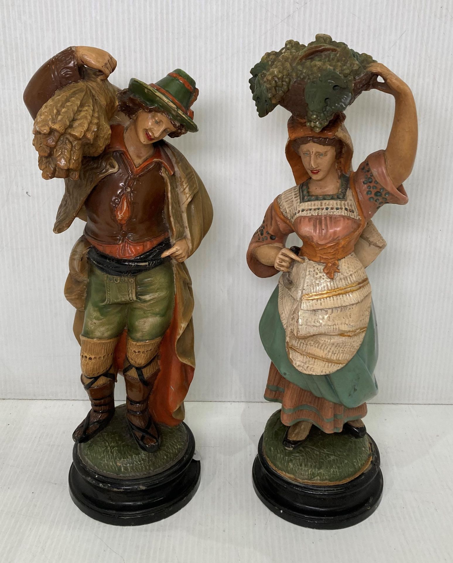 Two resin figurines of man and woman working, possibly Italian,