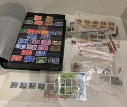 Green vinyl stamp album and large quantity of assorted Mint stamps and a envelope of assorted Mint