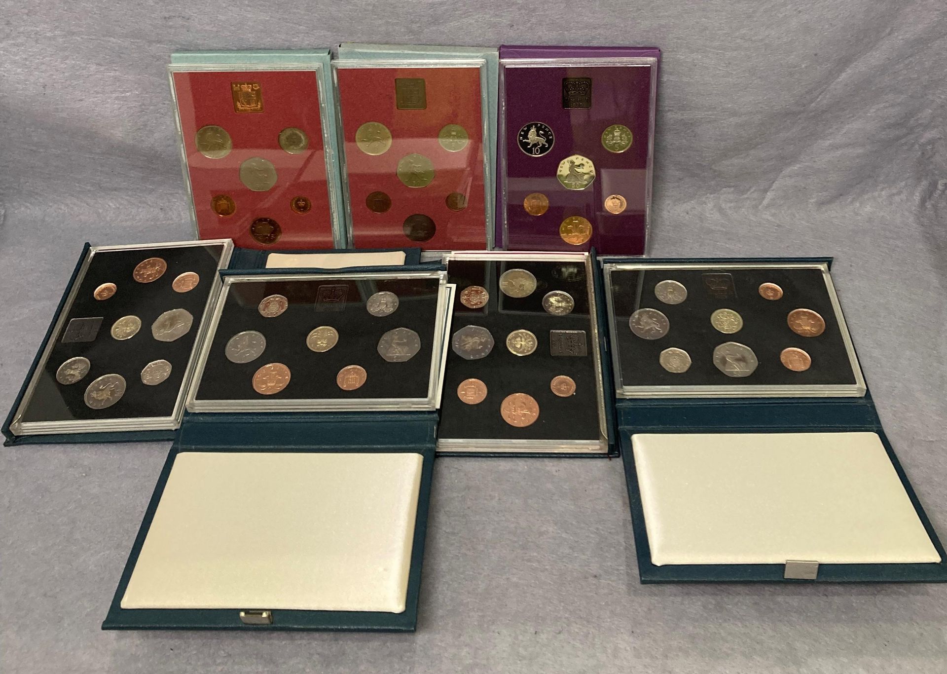 Seven assorted coin sets including 1983, two x 1984, 1985,