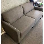 Modern grey fabric upholstered three seater settee on black legs,