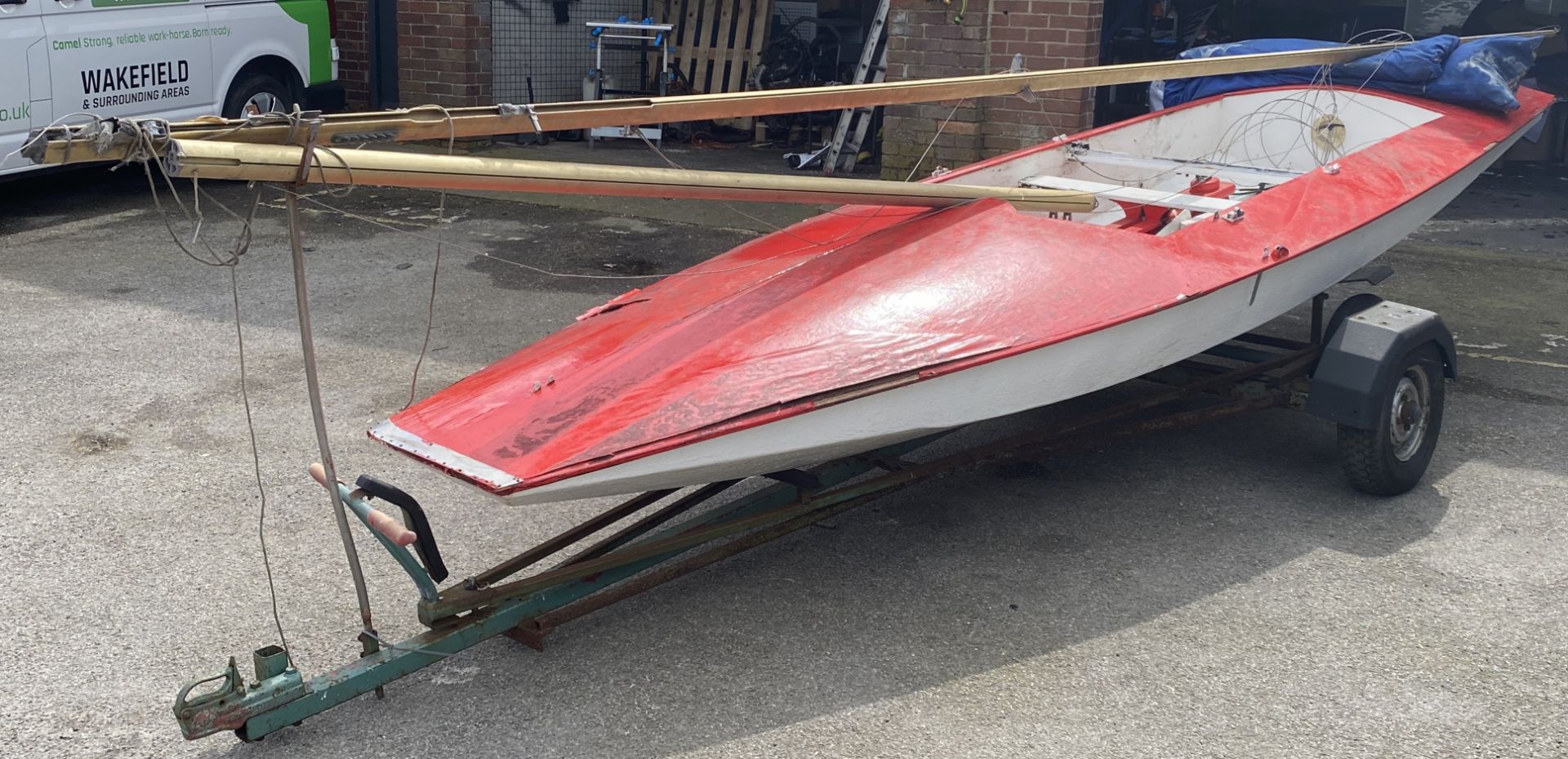 Red and white Fireball sailing boat with a 9' 9" (297cm) mast.
