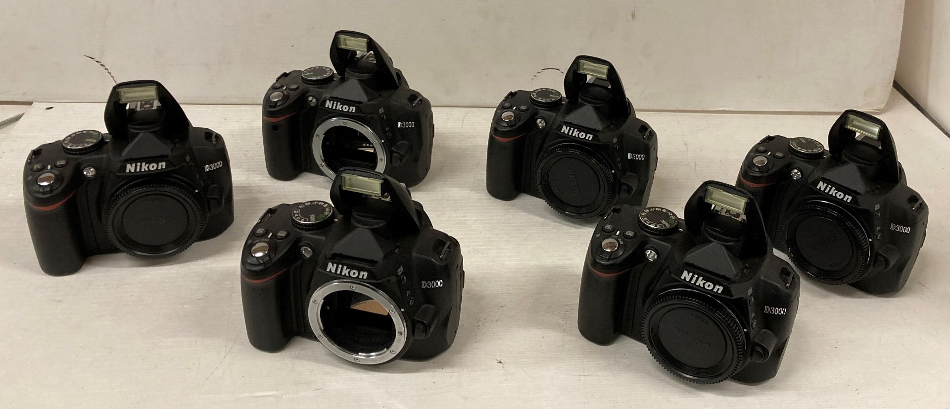 6 x Nikon D3000 camera bodies (sold as seen - flashes don't close) (saleroom location: J11)