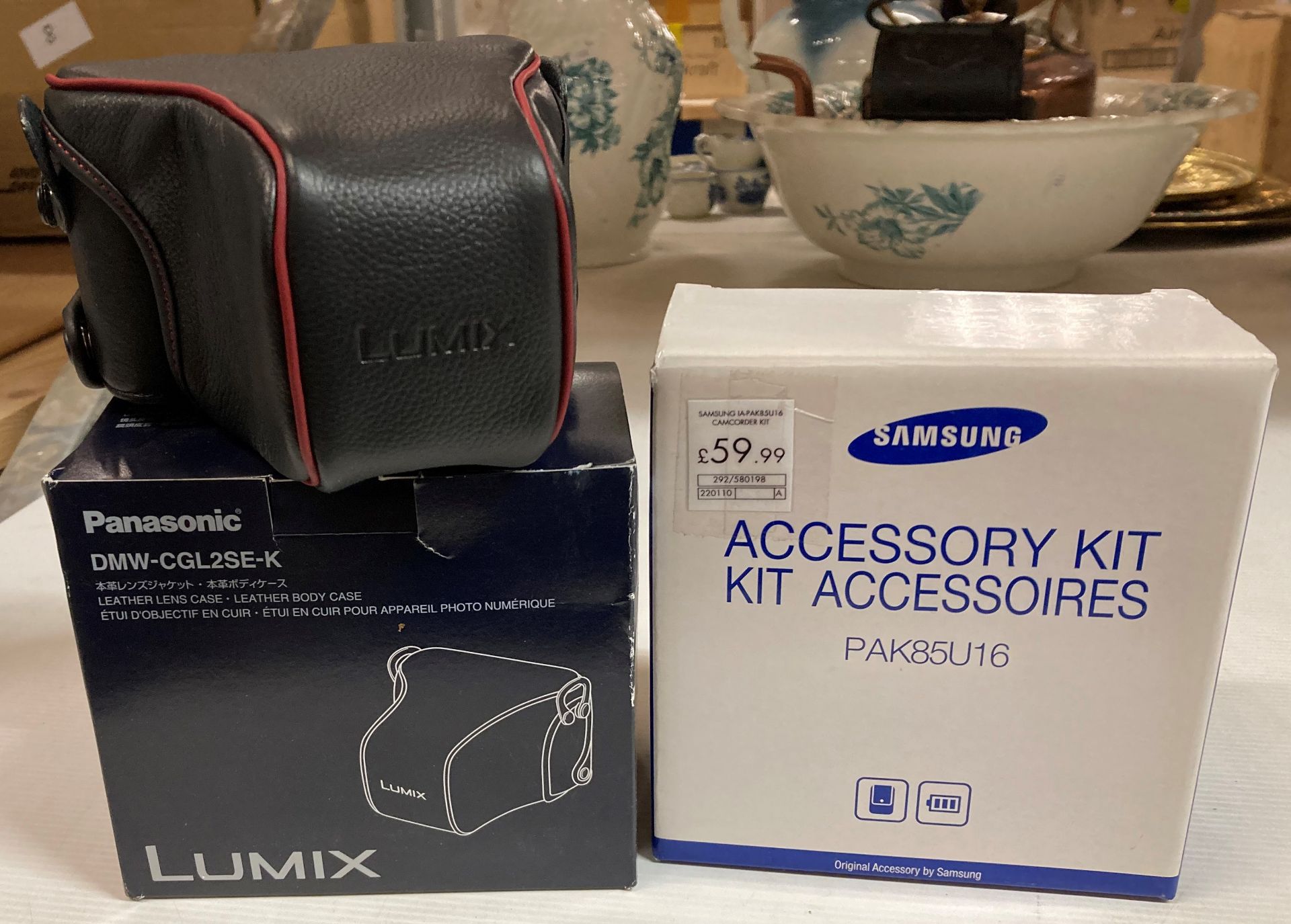 17 x Samsung PAK85U16 Accessory kits and 7 Panasonic DMW-CGK3 and DMW-CGL2SE-k leather camera cases