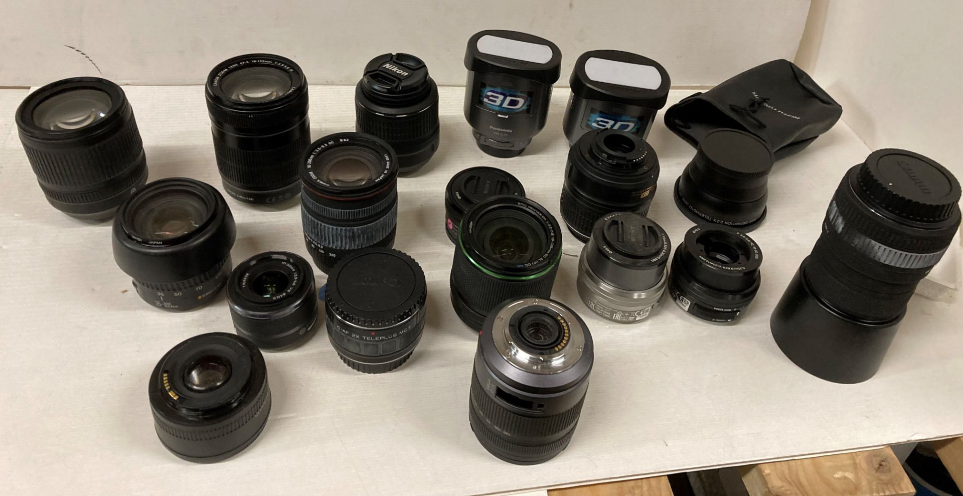 Contents to box - assorted camera lenses by Canon, Panasonic ,Pentax, Nikon,