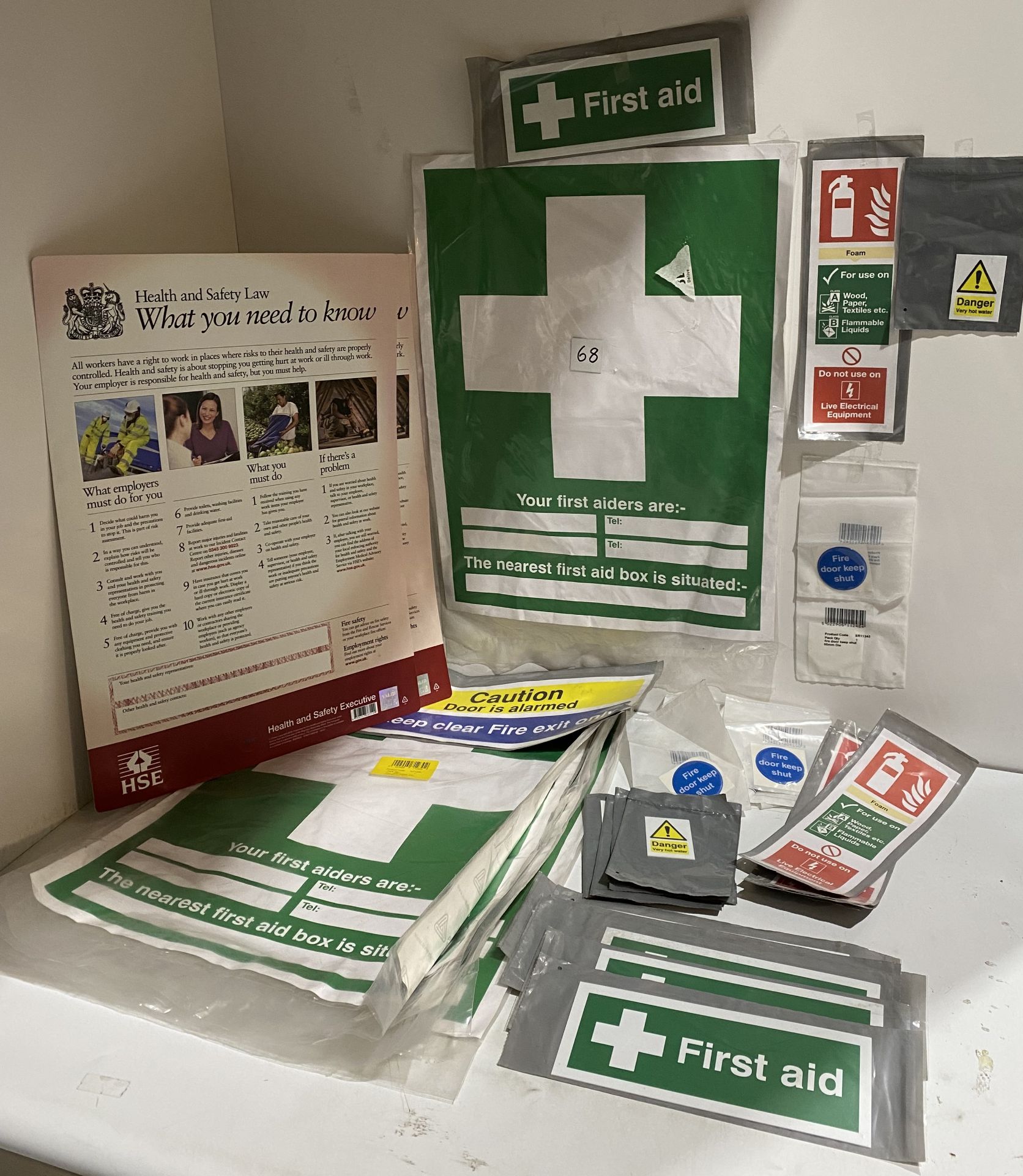 Assortment of Health and Safety signs - 24 x Fire Door Keep Shut domed 60mm, 6 x Your First Aiders,