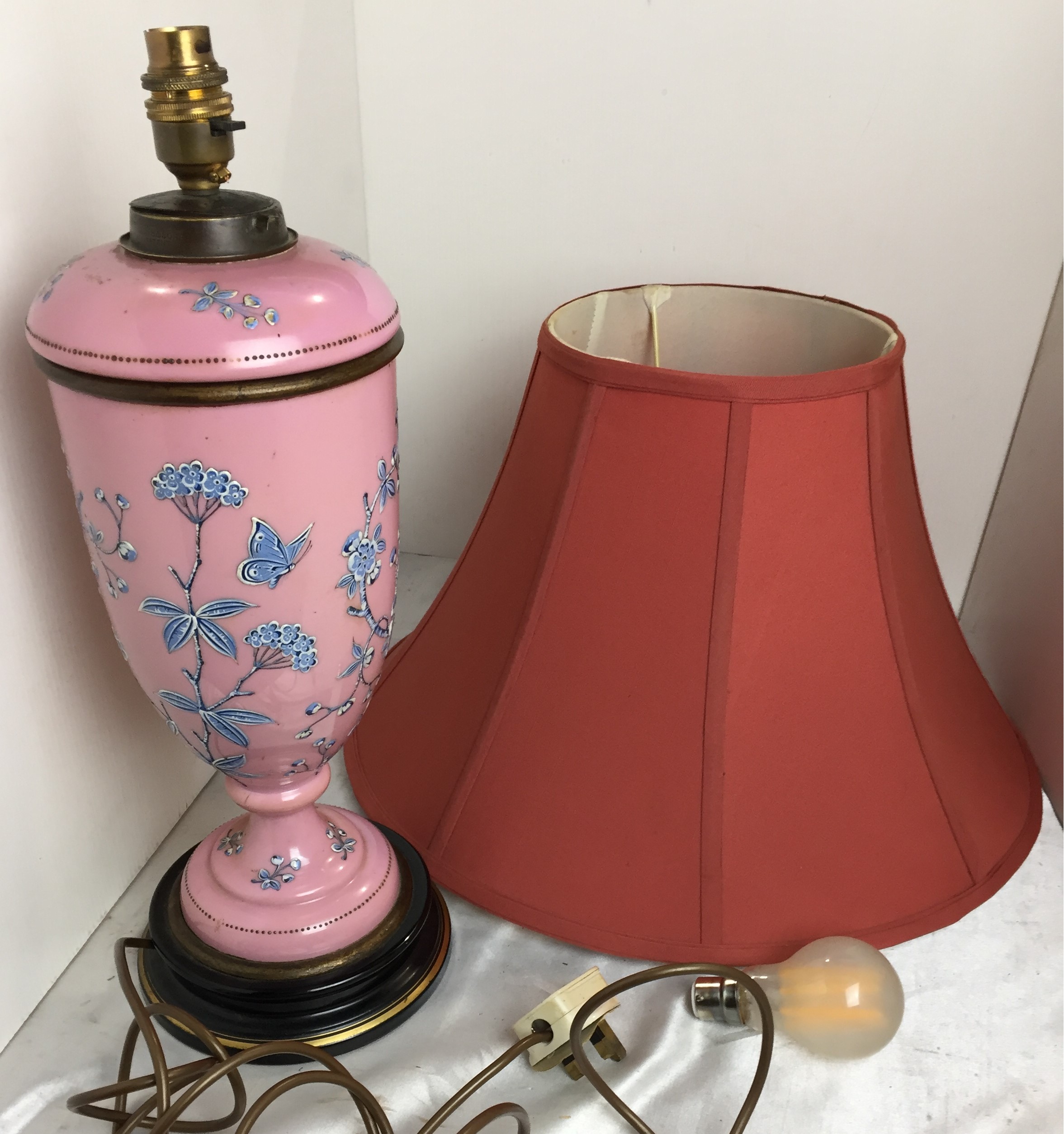 Two items - a pink glass and blue embossed pattern table lamp on black and gold base 46cm high and