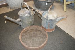 Two Galvanised Watering Cans and a Riddle