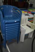 Three White and Ten Blue Plastic Stackable Patio Chairs