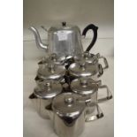 Seven Small and One Large Stainless Steel Teapots
