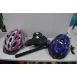 Two Bicycle Helmets, Saddle, and a Pump