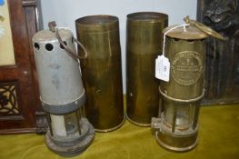 Two Miners Lamps by M&Q Eccles and Guys Shield, plus two Brass Shell Cases