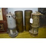 Two Miners Lamps by M&Q Eccles and Guys Shield, plus two Brass Shell Cases