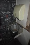 Stainless Steel Wash Hand Basin and a Paper Towel Dispenser