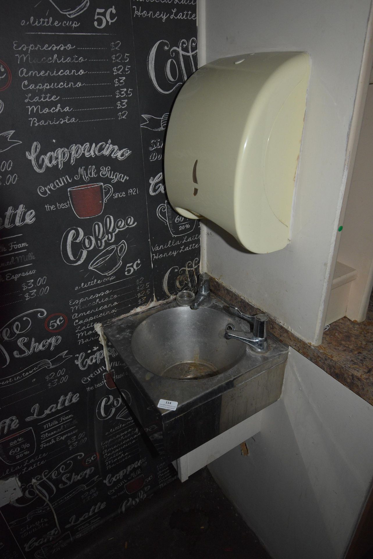 Stainless Steel Wash Hand Basin and a Paper Towel Dispenser