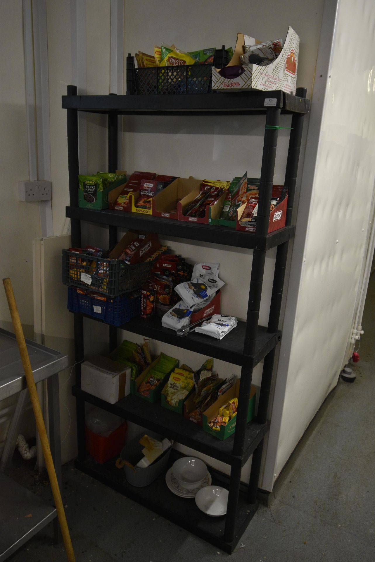 Five Tier Plastic Storage Rack Containing Assorted Herbs and Spices