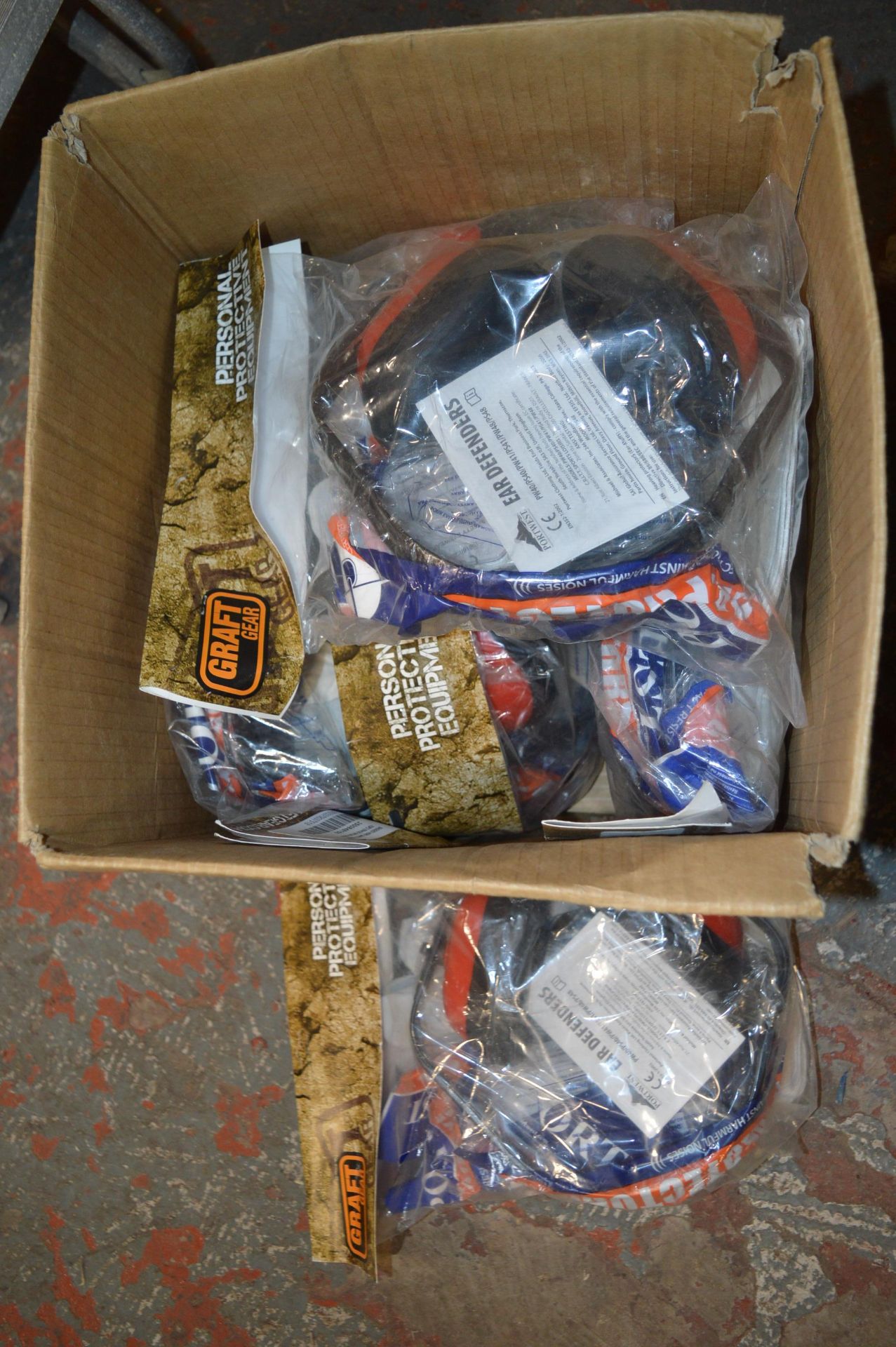Box of PPE Including Ear Defenders, Eye Protectors, and Safety Gloves