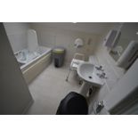 *Contents of Bathroom to Include Bath Chair, Wastebins, and a Toilet Riser