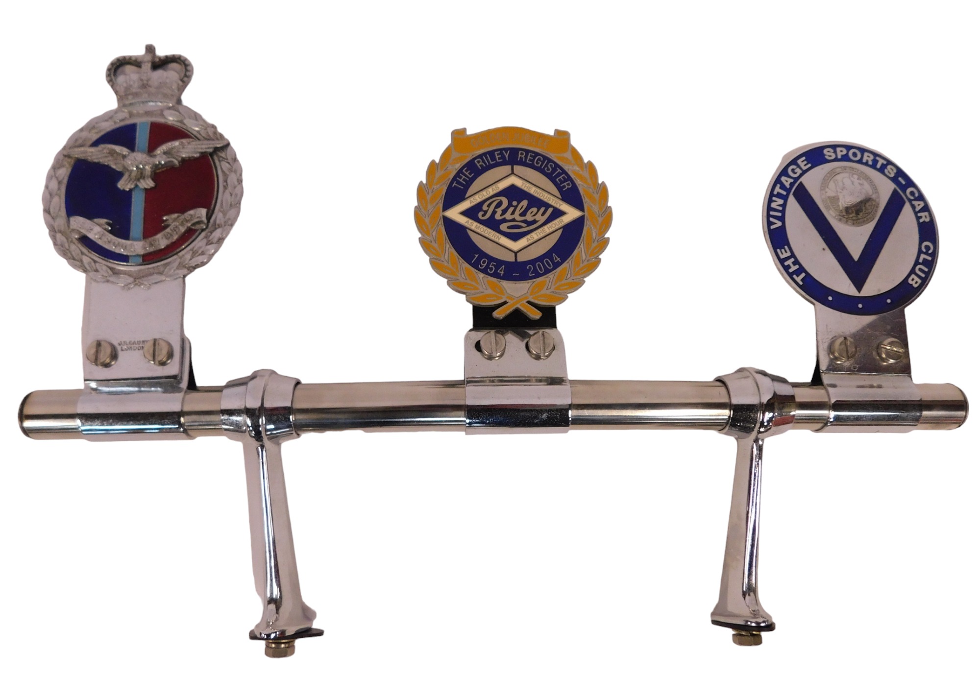 A chrome car badge bar, mounted with three enamel badges, to include Riley Register 1954-2004 Golden