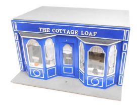 A model of The Cottage Loaf Cafe, 1:12 scale, with two bay windows, and other accessories.