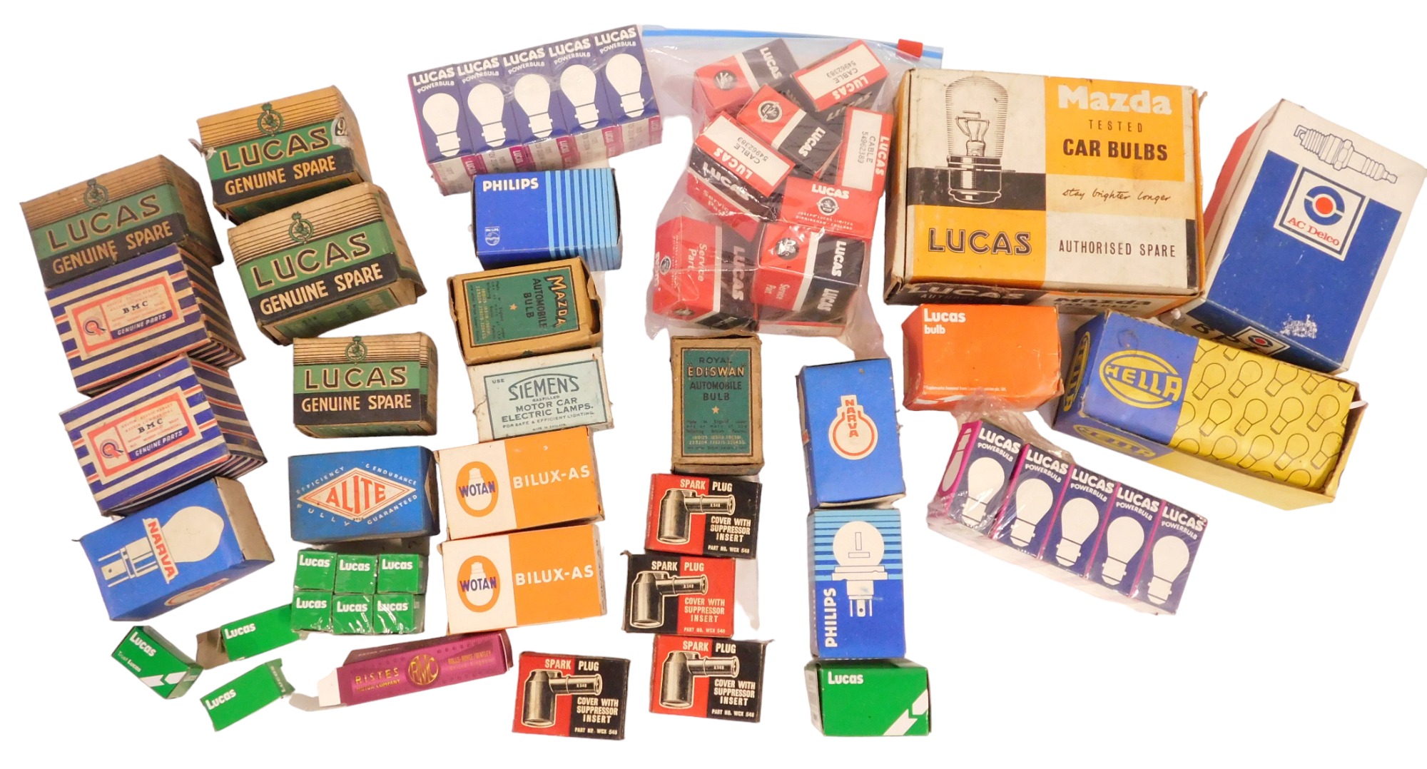 A group of automobile parts, to include Mazda, Philips, Lucas, and other bulbs and spark plug supres
