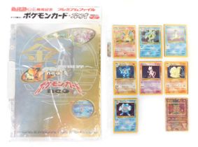 Pokemon hologram cards, including Charizard, Gyarados, Lampress, Machamp, Mewtwo, Nine Tails, Poliwr