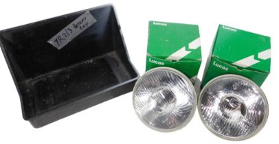 Lucas parts and spares, comprising two Lucas head lamp bulbs and a battery box. (3)