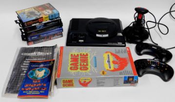 A Sega Mega Drive controllers, accessories and games, including The Terminator, Combat 3, Alien 3, D