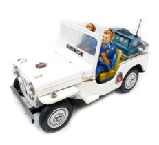 A TM Nomura tinplate battery operated Police Department Jeep.