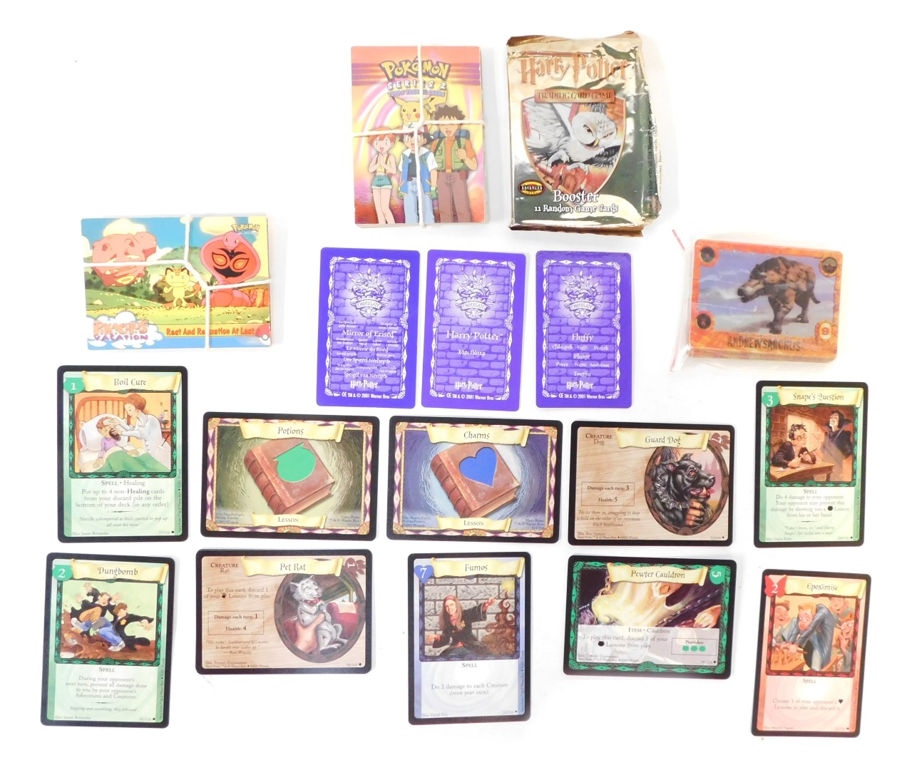 Various trading cards, including Harry Potter Trading game cards, Walking with Beasts, and twelve Po