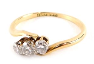 A Victorian three stone dress ring, set with three round brilliant cut diamonds, each in platinum cl