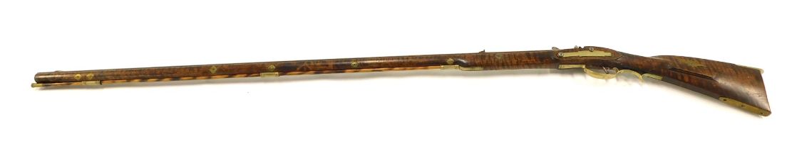 A 19thC flintlock Kentucky rifle with octagonal barrel, with fore and rear sights, with ramrod and f