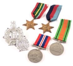 A group of WWII medals and badges, comprising defence medal, George VI coronation medal, Pacific Sta
