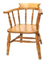 A 19thC beech and elm captain's chair, with spindle turned supports on turned legs.