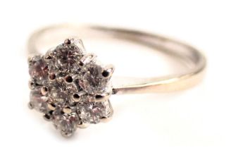 An 18ct white gold diamond cluster ring, set with seven round brilliant cut diamonds each in claw se