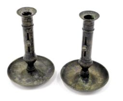 A pair of brass ejector candlesticks, each with a domed drip tray, 20cm high.