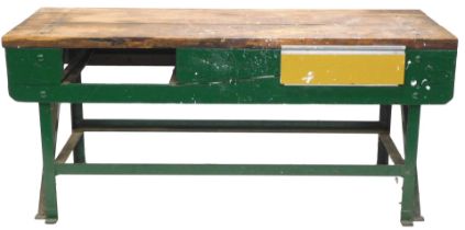 A work bench, with a plank top drawer, on a green painted steel base, 183cm wide. (AF)
