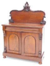 A Victorian mahogany chiffonier, the raised back with scroll carved borders, the base with frieze dr