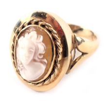 A 9ct gold cameo dress ring, the oval cameo depicting figure, in a rope twist rub over border with V