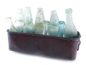 A collection of glass mineral bottles, and a copper rectangular jardiniere.