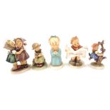 Five Goebel Hummel figures, to include children reading and playing. (5)