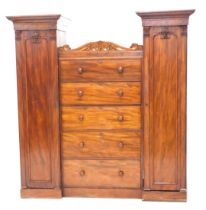 An early Victorian mahogany wardrobe, comprising two full length pedestal cupboards, each with a pan