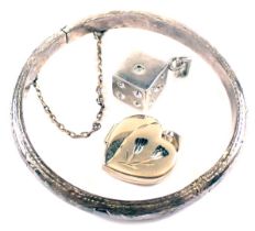 A silver child's bangle, 4cm diameter, 5.7g, a 9ct gold heart shaped locket, and a plated dice penda