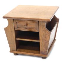 An oak Canterbury, the rectangular top above a drawer flanked by divisions for magazines, etc., 49cm