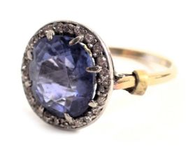 A sapphire and diamond cluster ring, the central oval faceted Ceylon sapphire 10mm x 9mm, approximat