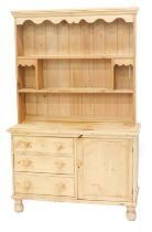 A Victorian pine dresser, the associated back with a moulded cornice and shaped apron, two shelves w