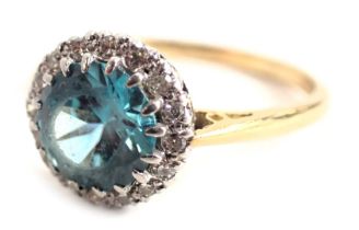 A blue zircon and diamond dress ring, the central round faceted zircon set in sixteen claws, approxi