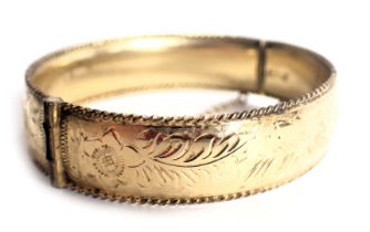 A 9ct gold filled hinged bangle, of floral design with rope twist border and safety chain, 6cm diame