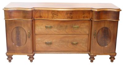 A Victorian mahogany sideboard, the serpentine fronted top with a moulded edge above three frieze dr